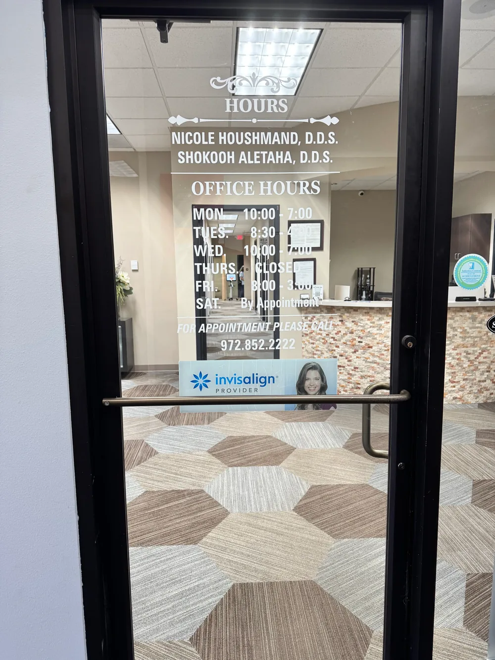 Front entrance of Spring Valley Dental Associates showing office hours and Dr. Houshmand and Dr. Aletaha